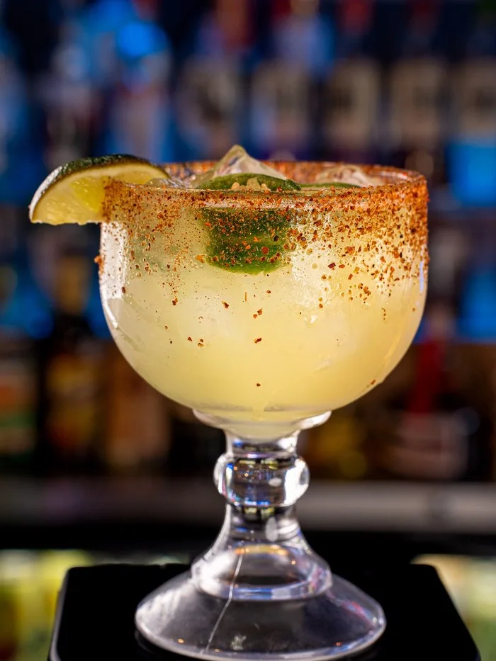 The Jalapeno Margarita with a chili-dusted rim, lime and fresh jalapeno