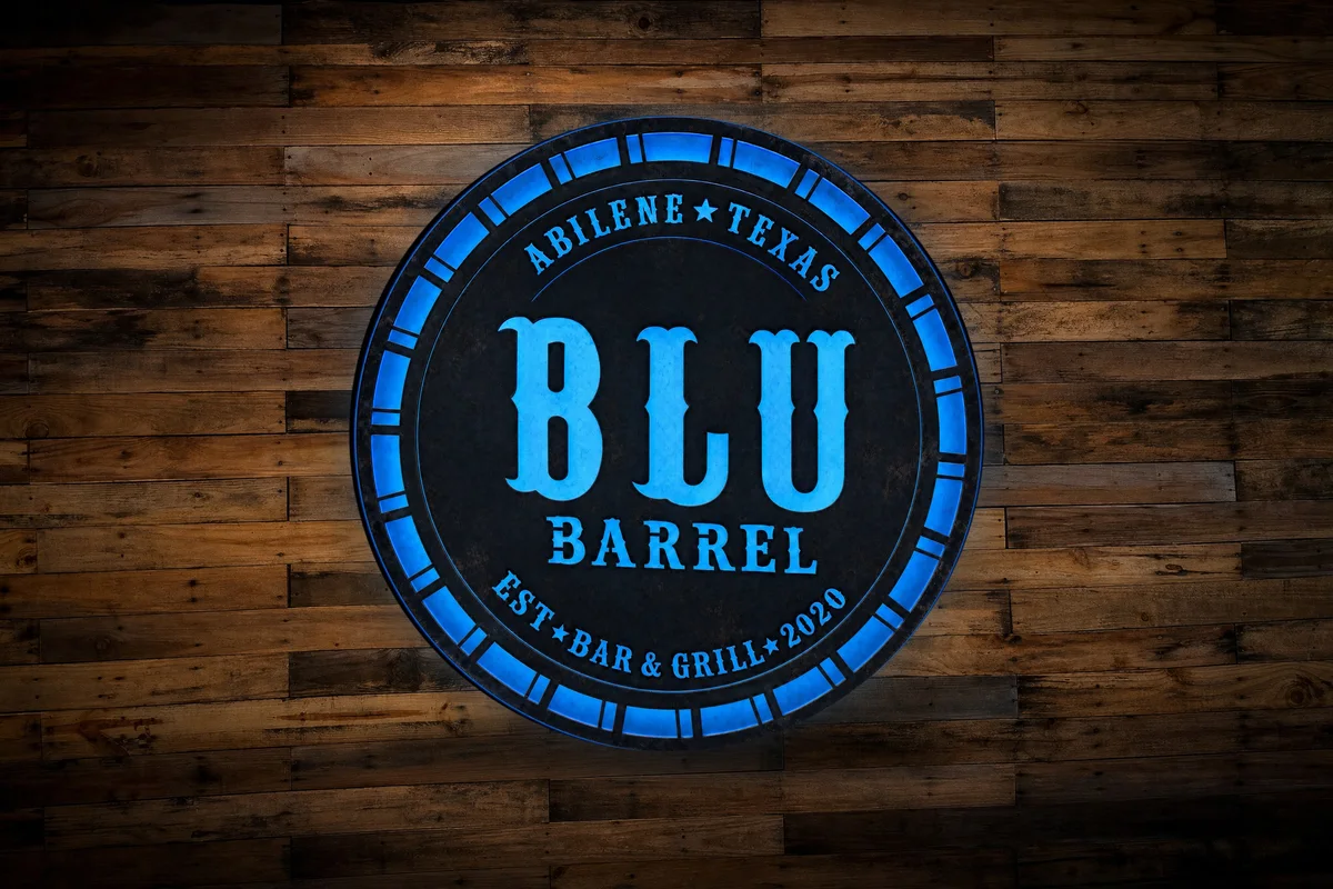 The backlit Blu Barrel bar and grill sign on a wood wall