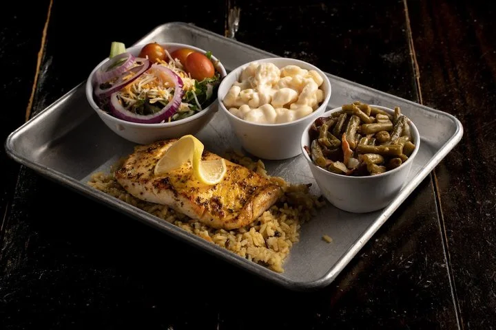 Grilled salmon on rice pilaf with two sides